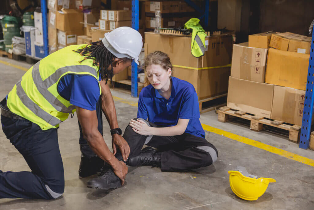 A woman who has fallen and injured her leg while working, highlighting the importance of liability insurance for businesses