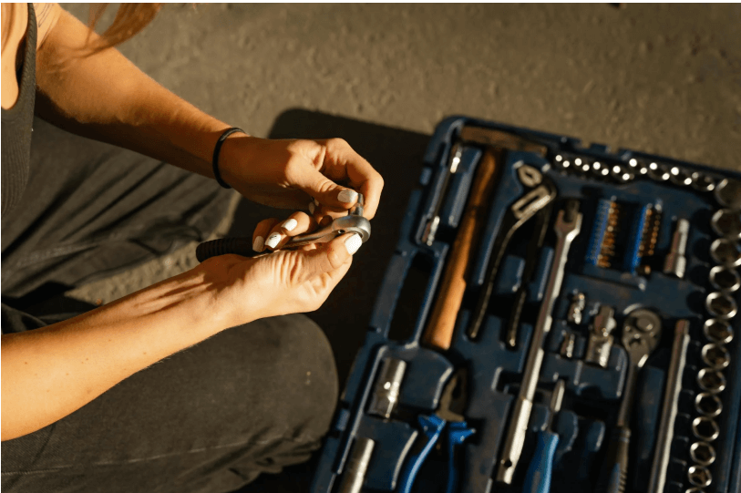 A Person Holding Steel Tool and a Bolt
